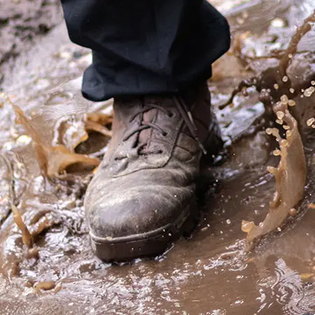 A brown Bates boot splashing in a puddle and link to our Airsoft Boots colection page