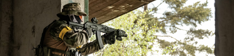 Airsoft player taking aim