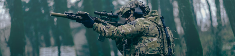 Airsoft player in dark woods