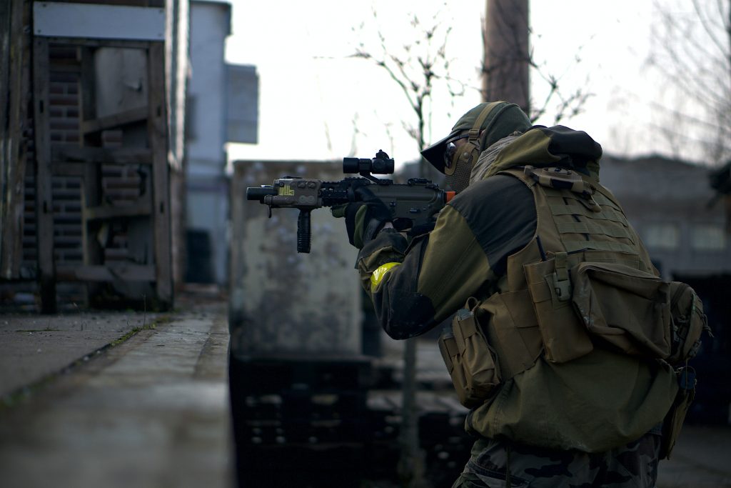 Man in camouflage jacket holding an airsoft gun