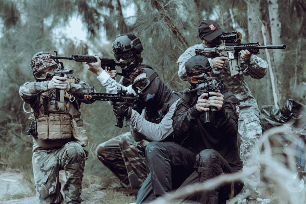 Group of airsoft plays in defensive positions