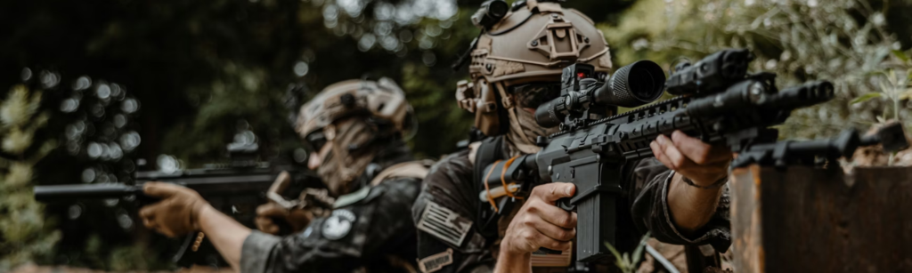 Airsoft players aiming guns