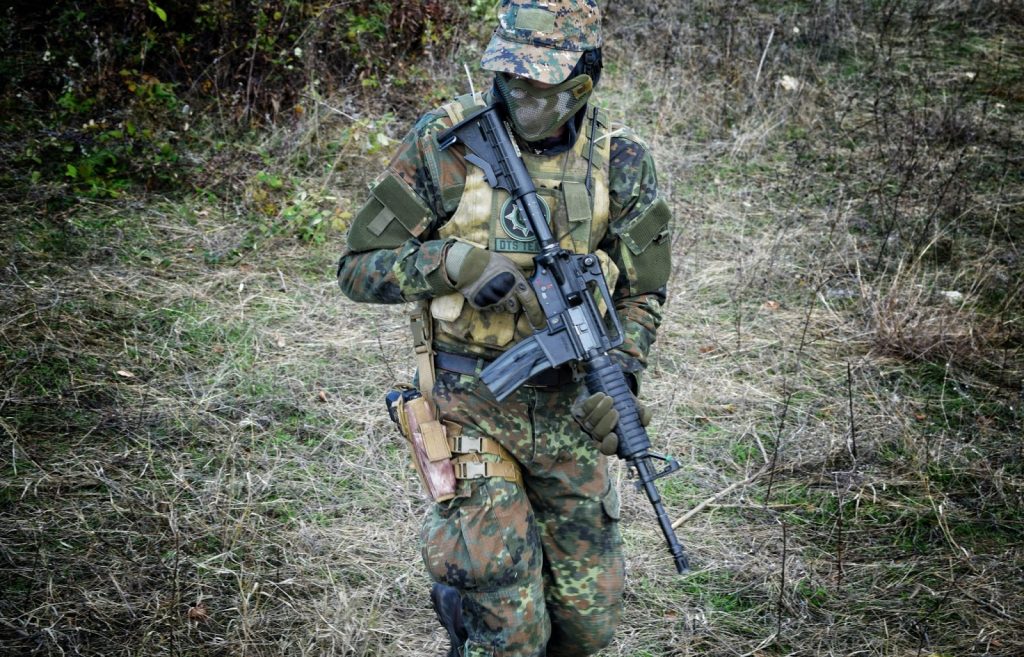 Airsoft player holding an airsoft rifle