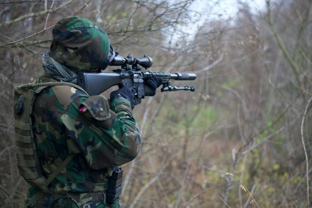 An airsofter aiming their gun