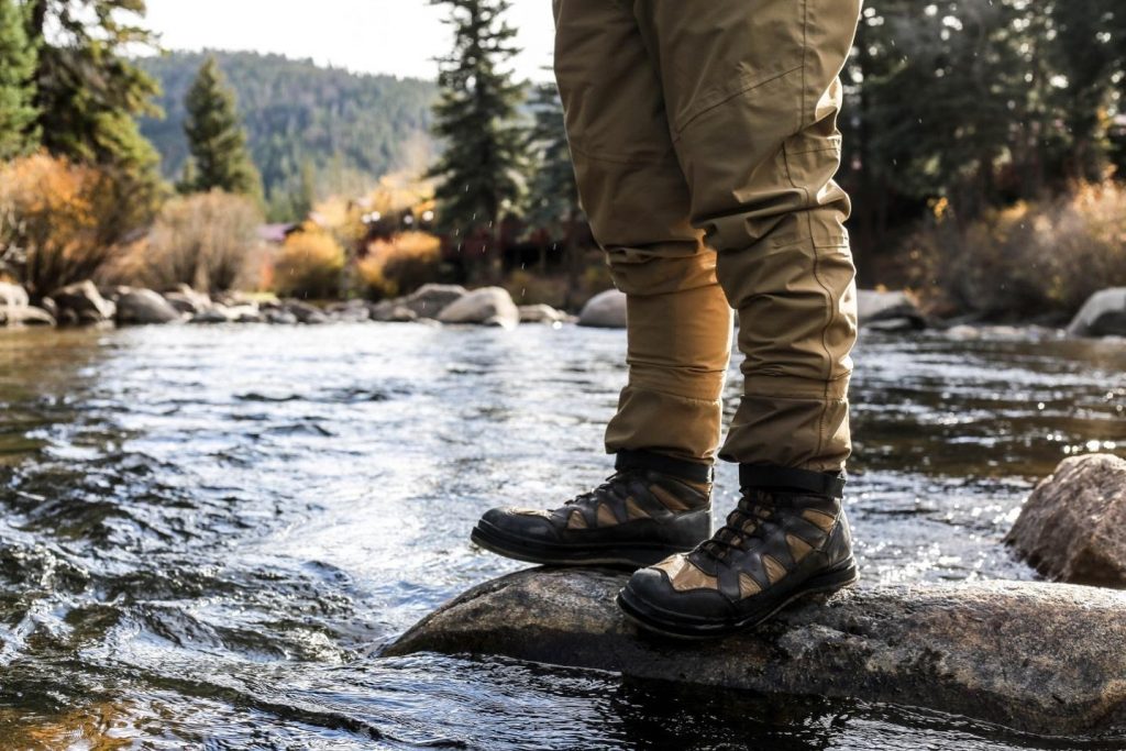 A man standing on a rock in the river