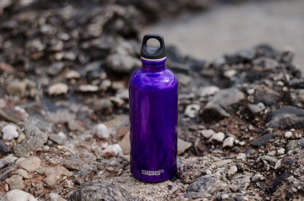 A water bottle on rocky terrain