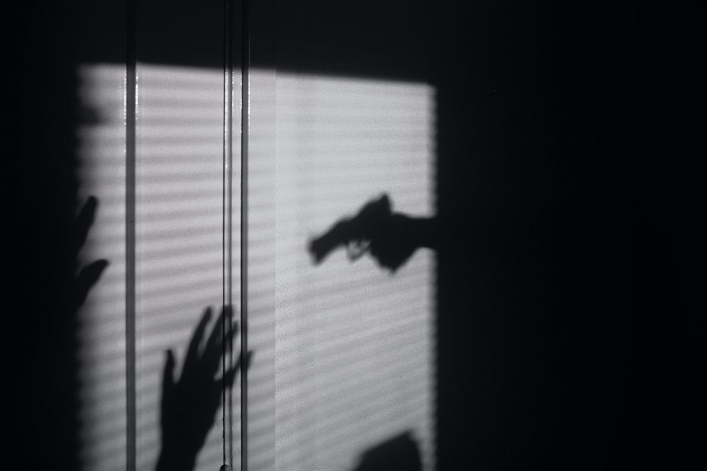 The shadow of someone shooting a gun