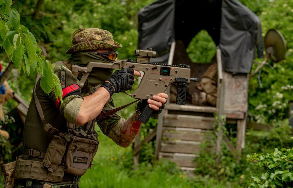 A man in camouflage with an airsoft gun