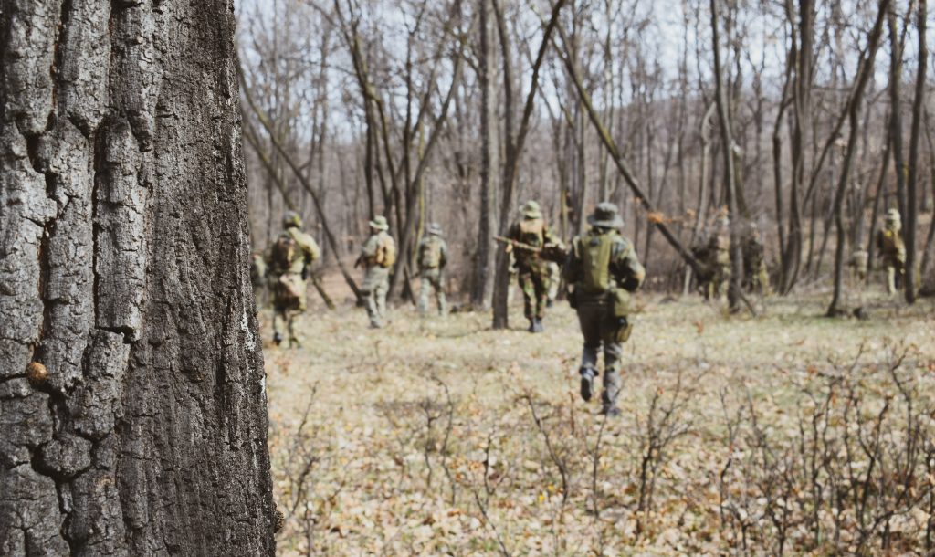 A group of airsoft players in the woods