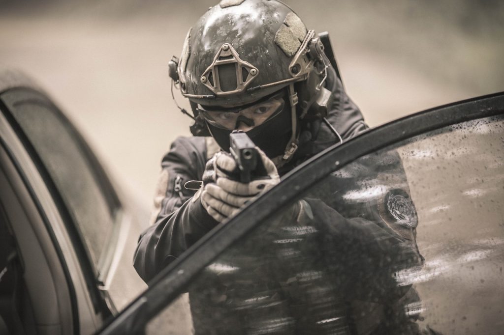 An airsoft player aiming a pistol