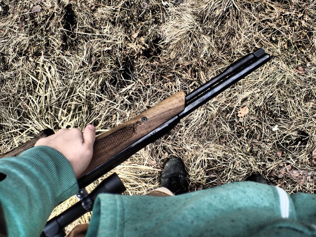 Someone holding an air gun 
