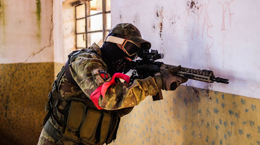 Airsoft player aiming a gun