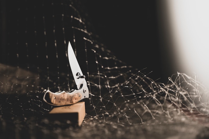 A folding knife half folded up