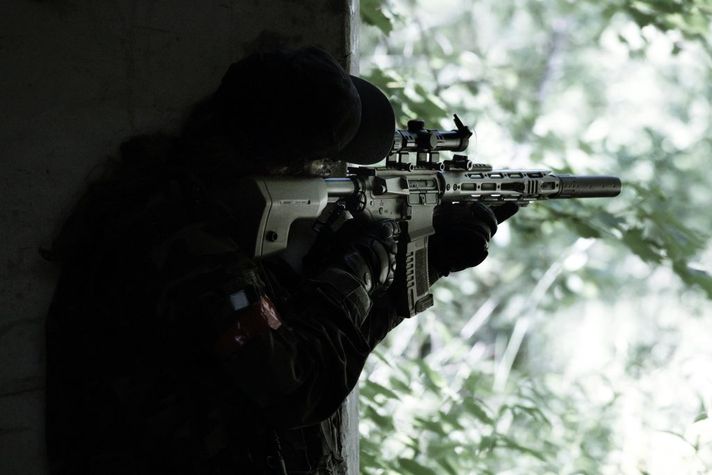 An airsoft player wearing black