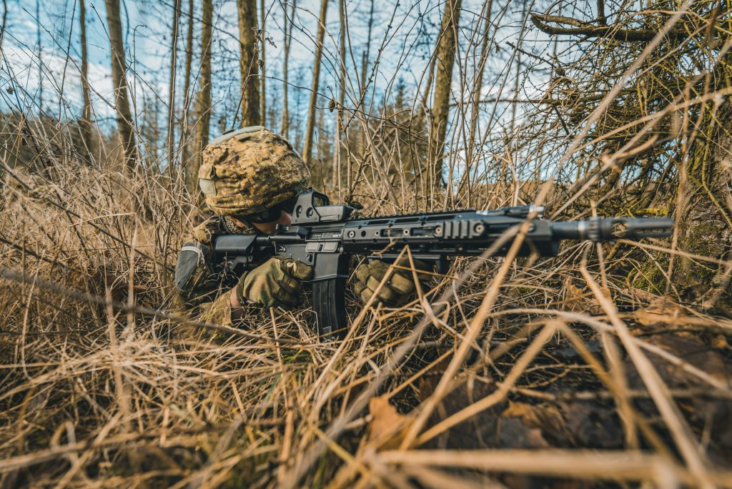 someone hiding in the bushes with an airsoft rifle