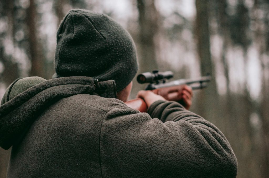 Man aiming rifle