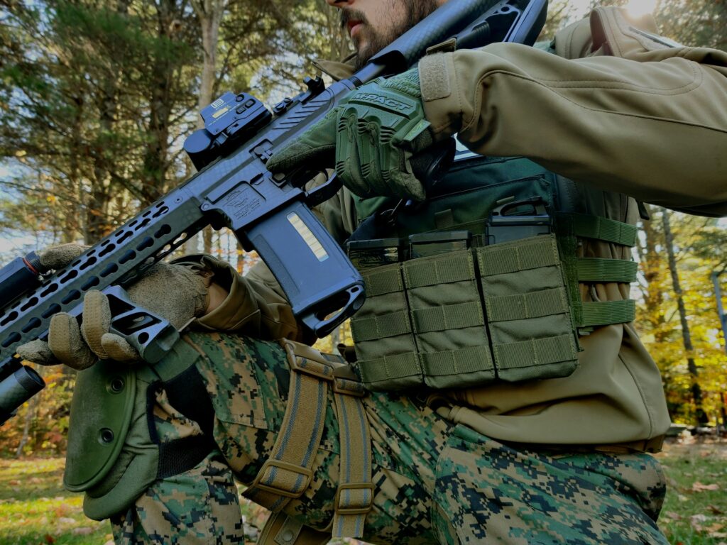 A person in military combat gear using the MOLLE system