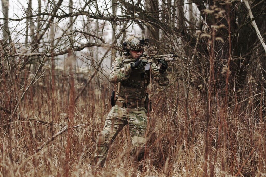 Man playing airsoft in the woods