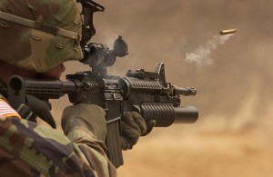Soldier firing an M4 Carbine - airsoft gun version available at Surplus Store