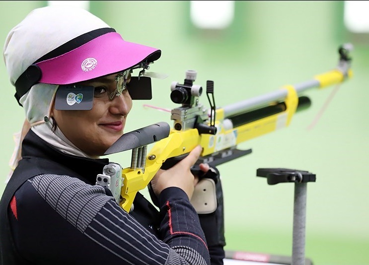 Female air rifle shooter wearing glasses