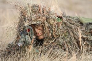 A sniper in a ghillie suit