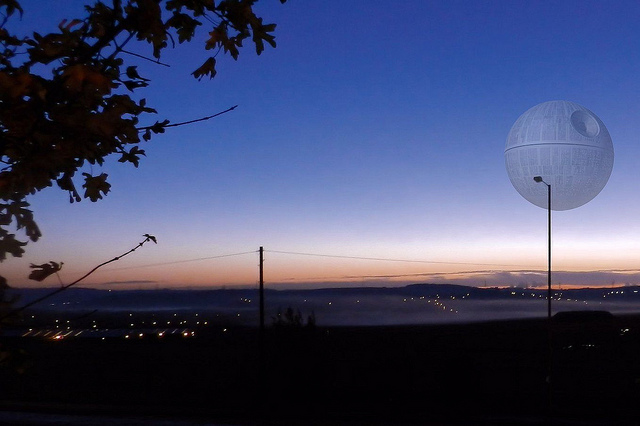 The Death Star from Star Wars floating above a cityscape