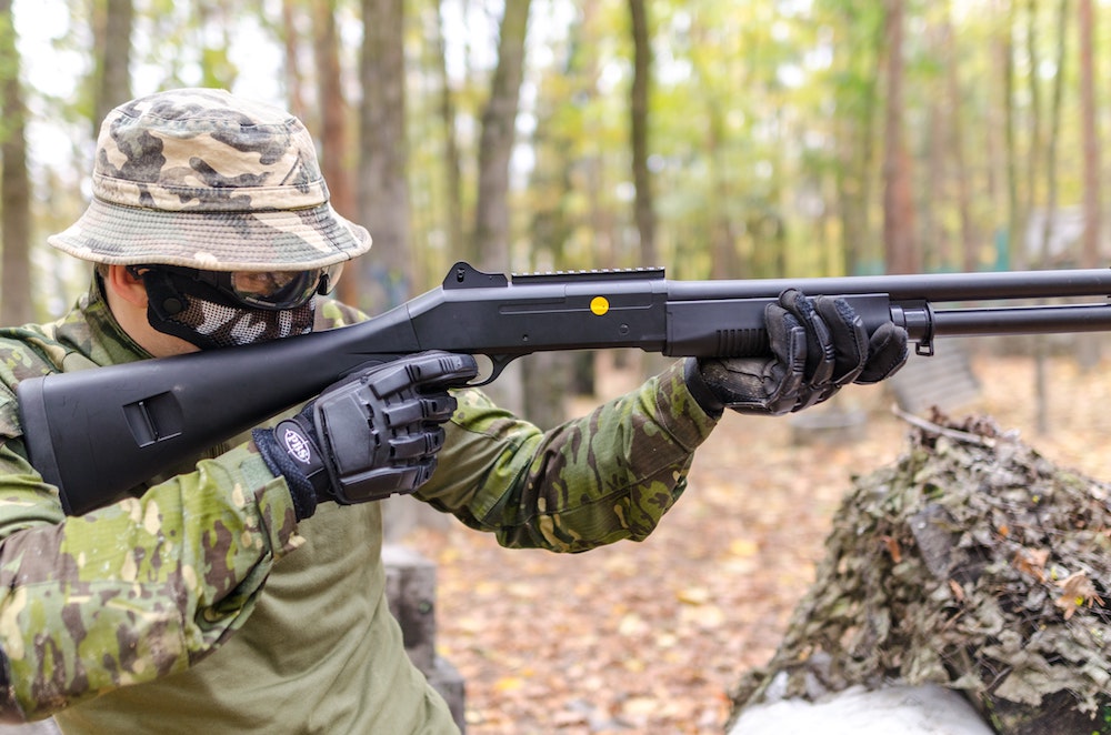 Man aiming down the sight of airsoft gun
