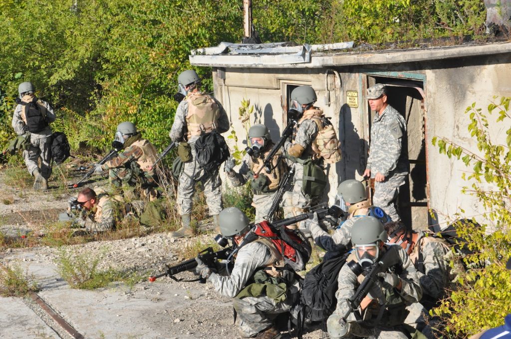 Airsoft players waiting and holding their air guns. 