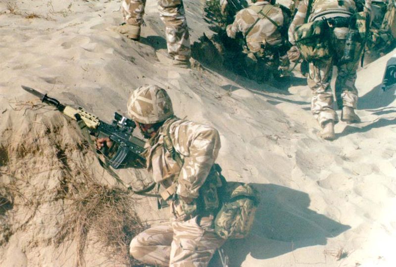 British soldier reloading the L85A1 behind cover in the desert