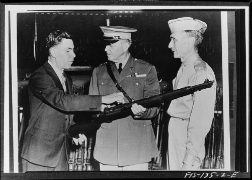 Garand shows rifle to generals. 