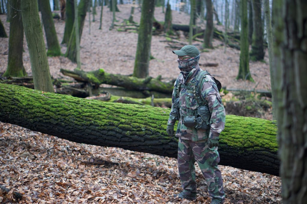 Person wearing camouflage long sleeve top and trousers