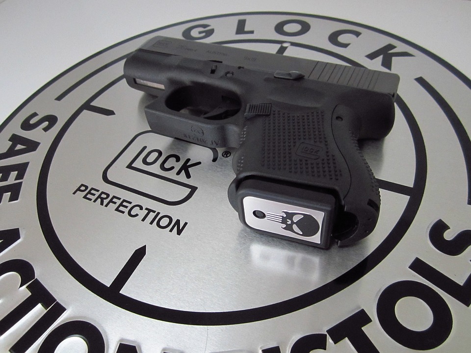 A Glock pistol resting on the Glock logo