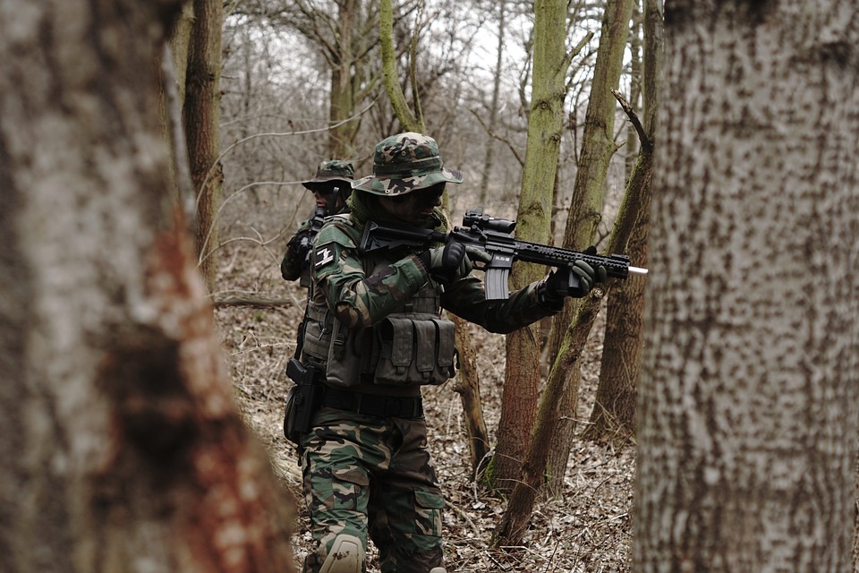 Man in woods playing airsoft