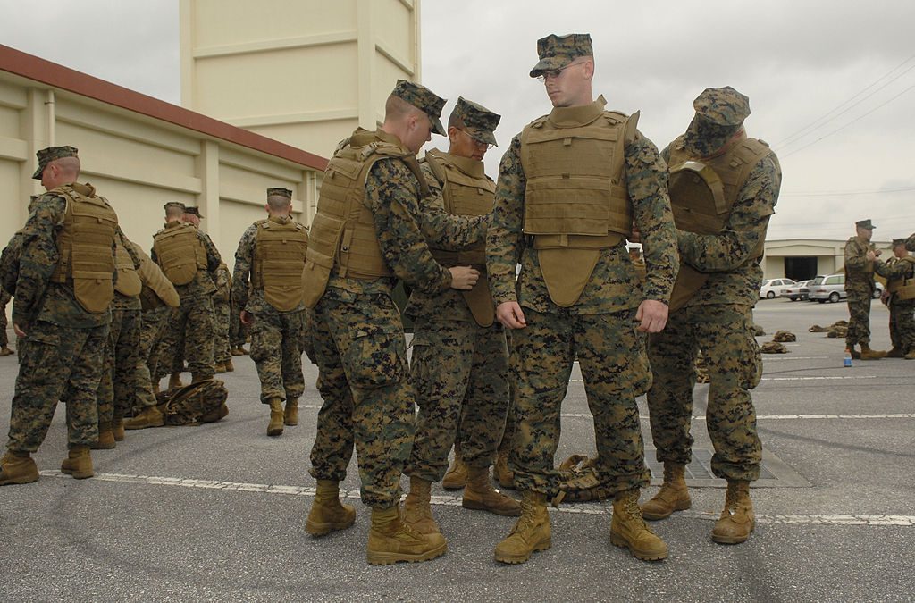 U.S. soldiers trying on bulletproof vests