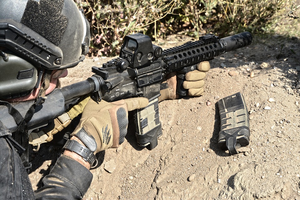 Airsoft player wearing tactical gloves