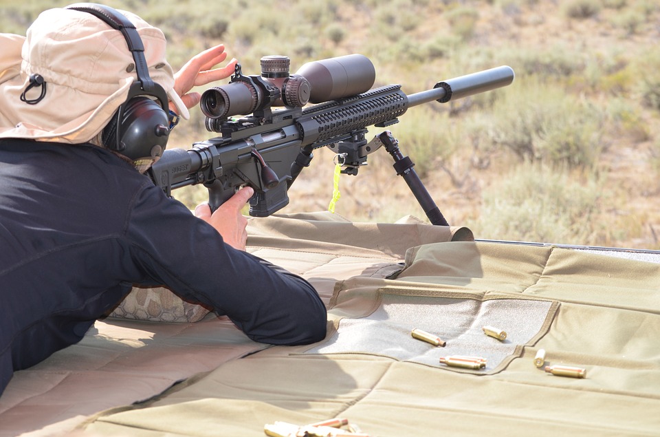 Man using a scope on rifle