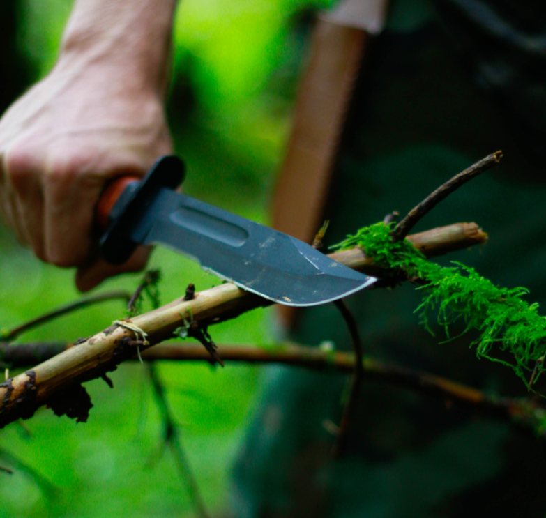 Person carving wood with a knife