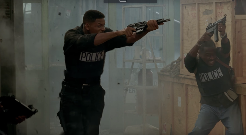 Two men holding submachine guns