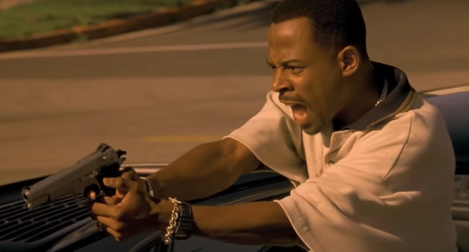 Martin Lawrence firing a pistol from a car