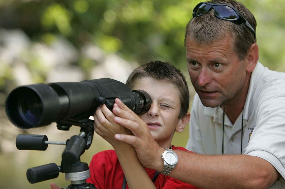 Person looking through spotting scope