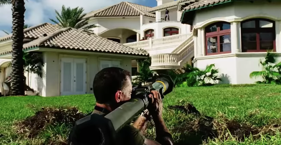 Man firing a rocket launcher at a building