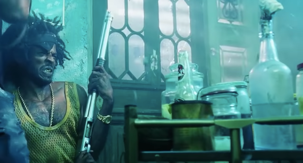 Man holding a long shotgun