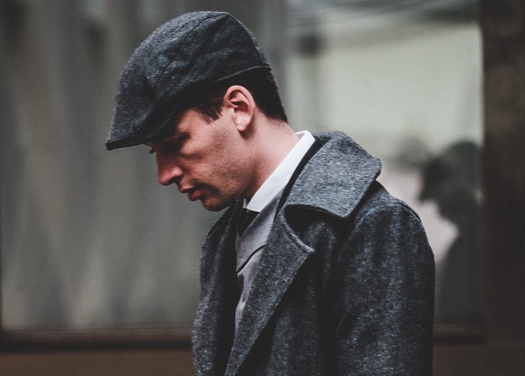 Man wearing cap and long coat